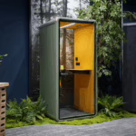 Hecor 1-person soundproof office phone booth in green exterior and yellow interior integrated into a biophilic workspace design